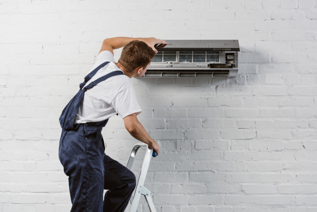 Whitestone technician fixing AC system in Coquitlam